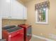 Convenient laundry room with white cabinets and Whirlpool appliances at 2554 Emerald Dr, Jonesboro, GA 30236