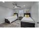 Cozy bedroom with two twin beds, neutral decor, and stylish ceiling fan at 749 Casplan Sw St, Atlanta, GA 30310