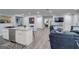 Spacious open living area with a kitchen island, modern appliances, and seating at 749 Casplan Sw St, Atlanta, GA 30310