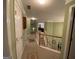 Upstairs hallway featuring neutral carpet, crown molding, and access to several rooms at 2691 Weatherstone Se Cir, Conyers, GA 30094