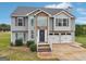 The attractive front exterior of the home featuring a stone front and a 2 car garage at 65 Randall Dr, Rockmart, GA 30153