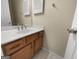 Bathroom vanity featuring wooden cabinets, white countertop, and classic fixtures at 9997 Point View Dr, Jonesboro, GA 30238