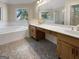 This bathroom features a double vanity, separate shower and bathtub, and stylish penny tile flooring at 9997 Point View Dr, Jonesboro, GA 30238