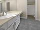Bathroom vanity featuring white cabinets, gray floors, and classic fixtures at 9997 Point View Dr, Jonesboro, GA 30238