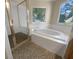 This bathroom features a separate shower and bathtub, and stylish penny tile flooring at 9997 Point View Dr, Jonesboro, GA 30238