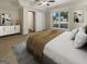 This virtually staged bedroom features plush carpeting and a large window for ample natural light at 9997 Point View Dr, Jonesboro, GA 30238