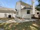 The house features white siding, a chimney, and a deck, complemented by a well-maintained lawn at 9997 Point View Dr, Jonesboro, GA 30238
