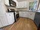 This kitchen features white cabinets, stainless steel appliances, and a cozy atmosphere with natural light at 9997 Point View Dr, Jonesboro, GA 30238