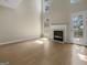 Bright living room features a cozy fireplace, hardwood floors and lots of natural light at 9997 Point View Dr, Jonesboro, GA 30238
