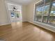 Bright living room featuring hardwood floors, large windows, and an open doorway at 9997 Point View Dr, Jonesboro, GA 30238