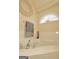 Bathroom with a soaking tub, tile surround, and elegant fixtures at 121 Pinnacle Ln, Mcdonough, GA 30253