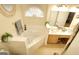 Bright bathroom featuring dual sinks, large tub, and modern finishes at 121 Pinnacle Ln, Mcdonough, GA 30253