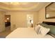 Bedroom showing tray ceiling, neutral colors, and access to ensuite bath at 121 Pinnacle Ln, Mcdonough, GA 30253