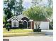 Charming brick home featuring well-manicured landscaping and a two-car garage at 121 Pinnacle Ln, Mcdonough, GA 30253