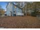 Home's backyard, showcasing a deck and surrounding trees at 1008 King Rd, Riverdale, GA 30296