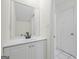 Clean bathroom with white vanity and a large mirror at 1008 King Rd, Riverdale, GA 30296