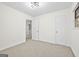 Spacious bedroom with neutral walls, carpeting, and access to a hallway at 1008 King Rd, Riverdale, GA 30296