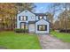 Newly painted 2-story house with a well-manicured lawn and driveway at 1008 King Rd, Riverdale, GA 30296