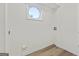 Basement laundry area with vinyl flooring and a circular window at 1008 King Rd, Riverdale, GA 30296