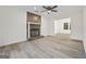 Living room with a stone fireplace and wood-look flooring at 1008 King Rd, Riverdale, GA 30296