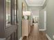 Bright entryway with dark wood door and light wood console table at 564 Parnassus Road, Locust Grove, GA 30248