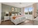Bright bedroom with a queen-size bed, nightstands, and large window at 576 Parnassus Road, Locust Grove, GA 30248