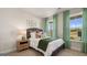 Cozy bedroom with full-size bed and green curtains at 576 Parnassus Road, Locust Grove, GA 30248