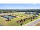 Aerial view showing tennis courts and open green spaces at 576 Parnassus Road, Locust Grove, GA 30248
