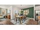Charming dining area with wood table and green accent wall at 576 Parnassus Road, Locust Grove, GA 30248