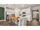Modern kitchen with island, stainless steel appliances, and white cabinetry at 576 Parnassus Road, Locust Grove, GA 30248