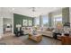 Relaxing living room featuring a sectional sofa and large windows at 576 Parnassus Road, Locust Grove, GA 30248
