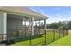 Spacious screened porch with seating area and ceiling fan at 576 Parnassus Road, Locust Grove, GA 30248