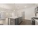 Modern kitchen with island, stainless steel appliances, and hardwood floors at 568 Parnassus Rd, Locust Grove, GA 30248