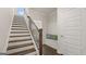 Elegant staircase with dark wood treads and a modern metal railing at 568 Parnassus Rd, Locust Grove, GA 30248