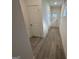 Bright hallway with light wood-look flooring and neutral walls at 5802 Calle Vista Dr, Lithonia, GA 30058