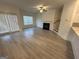 Spacious living room featuring hardwood floors, a fireplace, and access to a patio at 5802 Calle Vista Dr, Lithonia, GA 30058