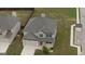 Captivating aerial view of a two-story home with a brick facade, attached garage, and manicured lawn in a suburban neighborhood at 1223 Hartwell Rd, Locust Grove, GA 30248