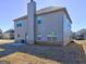 A well-maintained yard with a chimney, patio, and gray siding at 1223 Hartwell Rd, Locust Grove, GA 30248