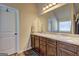 Well-lit bathroom with a double vanity, granite countertops, and a separate shower at 1223 Hartwell Rd, Locust Grove, GA 30248