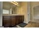 Bathroom featuring a double vanity, granite countertops, and a wood-look tile floor at 1223 Hartwell Rd, Locust Grove, GA 30248