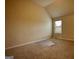 Unfurnished carpeted bedroom with sloped ceiling, window, and ample space at 1223 Hartwell Rd, Locust Grove, GA 30248