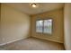 Neutral bedroom with a window that brings in lots of natural light and neutral carpeting at 1223 Hartwell Rd, Locust Grove, GA 30248