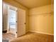 Unfurnished bedroom with carpet flooring and walk-in closet near an ensuite bathroom at 1223 Hartwell Rd, Locust Grove, GA 30248