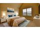 This staged bedroom has a bed with blue accent pillows, a night stand, and modern art at 1223 Hartwell Rd, Locust Grove, GA 30248