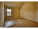 Unfurnished bedroom with sloped ceiling, carpet flooring, and window at 1223 Hartwell Rd, Locust Grove, GA 30248
