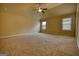 Spacious bedroom featuring a ceiling fan and two large windows at 1223 Hartwell Rd, Locust Grove, GA 30248