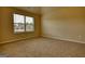Spacious carpeted bedroom with large window providing abundant natural light at 1223 Hartwell Rd, Locust Grove, GA 30248