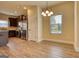 Bright dining area featuring wood floors, chandelier, and stainless steel appliances in the open kitchen at 1223 Hartwell Rd, Locust Grove, GA 30248