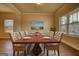 Formal dining room with wood floors, picture window, dining table, and seating for eight at 1223 Hartwell Rd, Locust Grove, GA 30248