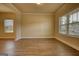 Spacious living room with wood floors, neutral walls, large windows, and abundant natural light at 1223 Hartwell Rd, Locust Grove, GA 30248